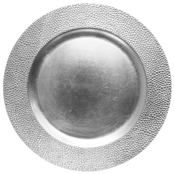 A close up of a silver pebbled Charge It by Jay charger plate with a circular design.