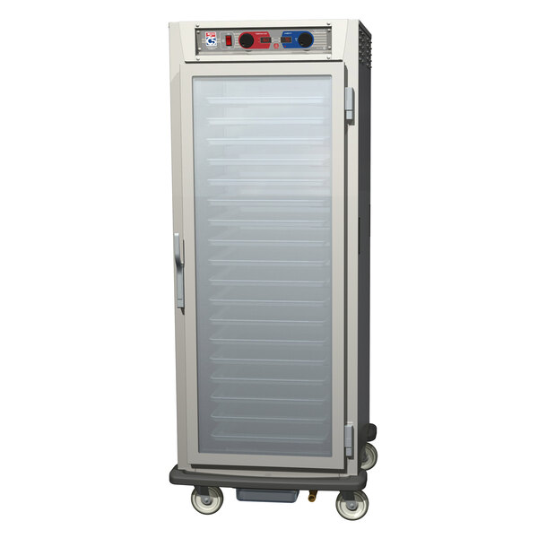 A stainless steel Metro C5 pass-through holding and proofing cabinet with clear glass doors on wheels.