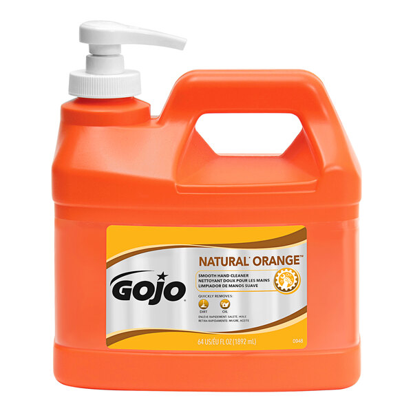 A plastic bottle of GOJO Natural Orange hand soap with orange liquid.