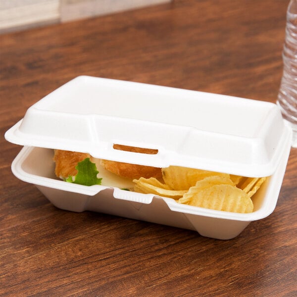 A white Genpak foam hinged lid container with food inside.