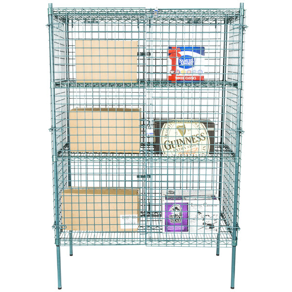 A green wire security cage with metal racks holding boxes.