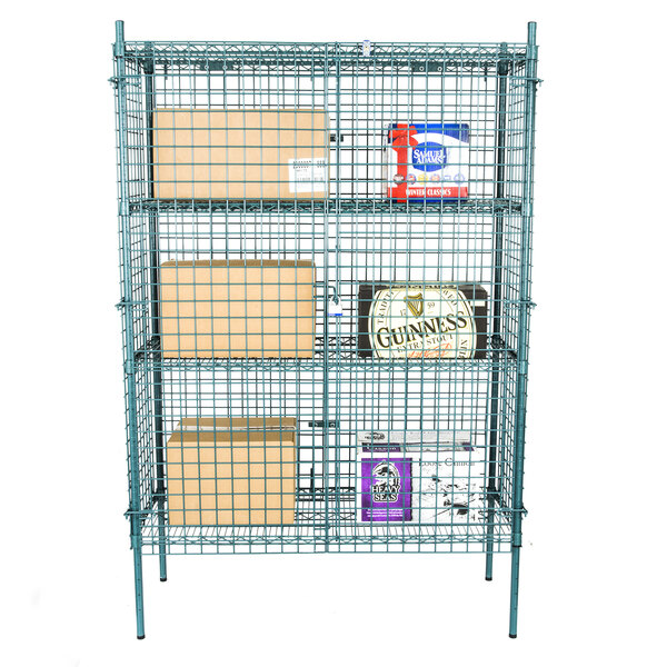 A Regency green wire security cage kit with shelves and boxes inside.