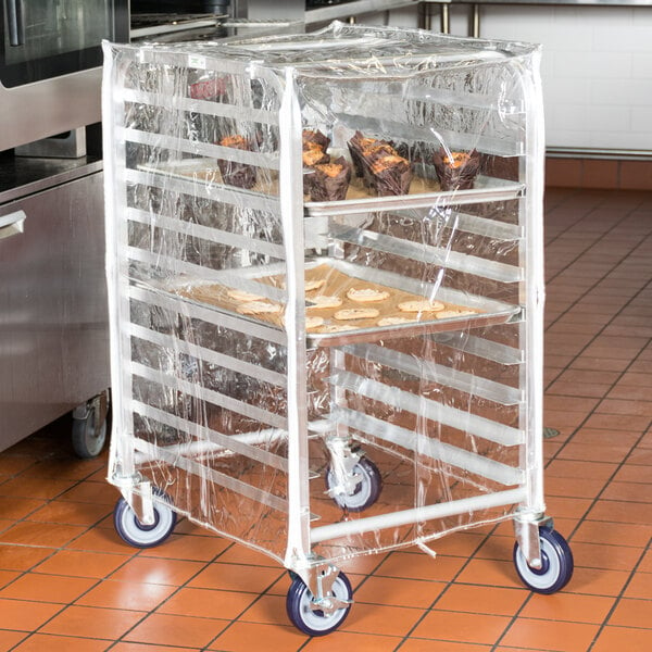 A Regency clear plastic bun pan rack cover with zippers on a bun pan rack filled with food.