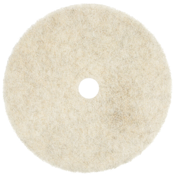 A white circular Scrubble burnishing pad with a hole in the center.