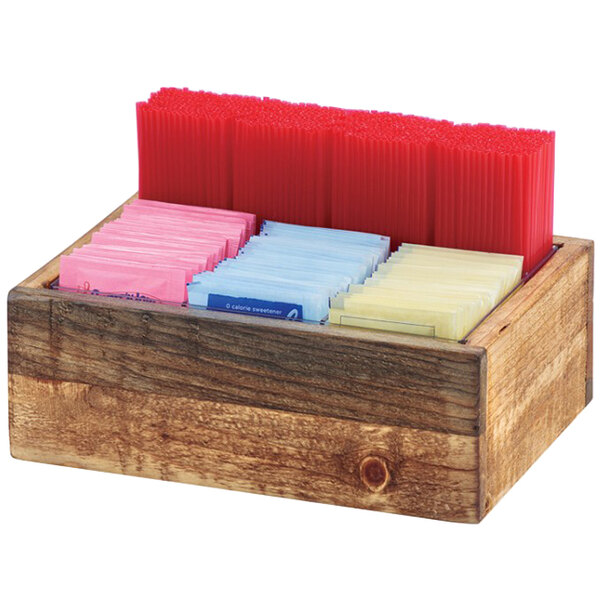 A Cal-Mil Madera wooden condiment holder with different colored packets inside.