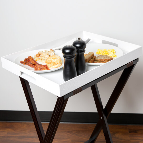 A white Cal-Mil plastic room service tray with breakfast food on it.