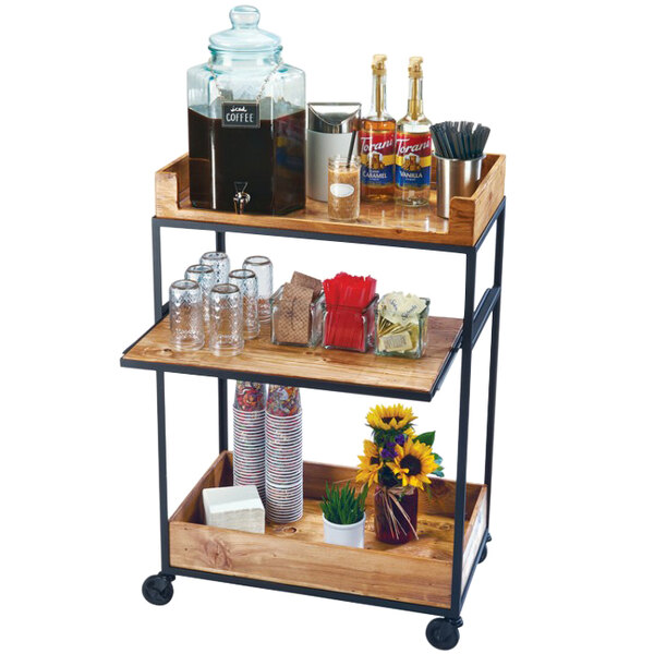 A Cal-Mil Madera rustic pine 3-tier beverage cart with drinks and glasses on it.