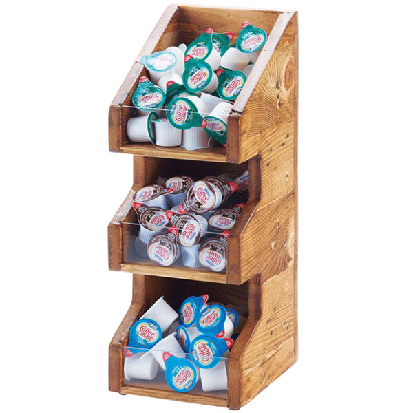 A Cal-Mil Madera rustic pine wooden display shelf with clear bins holding coffee condiments.