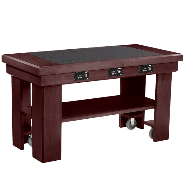 A mahogany buffet table with black induction warmers on wheels.