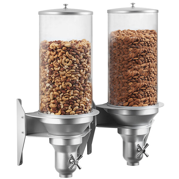 A Cal-Mil wall mount cereal dispenser with two silver containers of nuts inside.