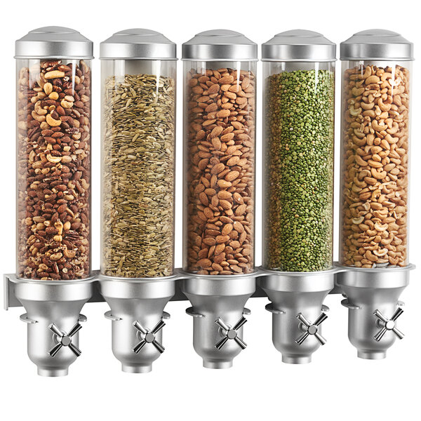 A Cal-Mil platinum wall mount cereal dispenser with 5 canisters filled with different types of nuts.
