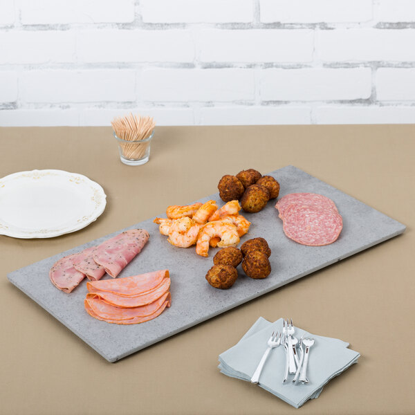 A Cal-Mil rectangular faux cement serving platter with meat, vegetables, and toothpicks on it.