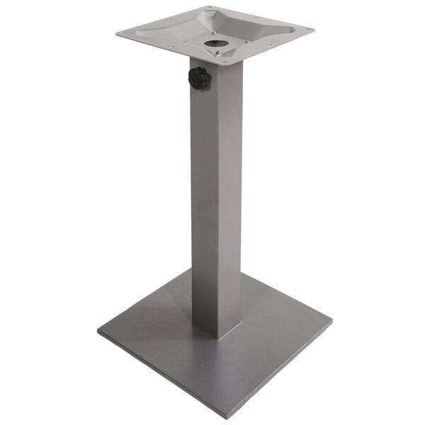 A metal stand with a square base and a hole in the middle.