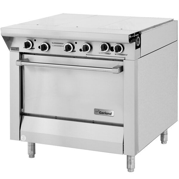 A large stainless steel Garland Master Series liquid propane hot top range with storage base.