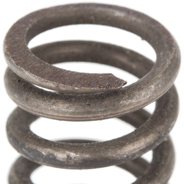 A close-up of an Avantco lock spring with a metal ring on top.