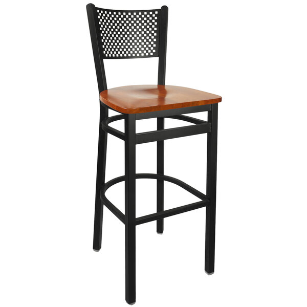 A BFM Seating black metal bar height chair with a cherry wood seat.