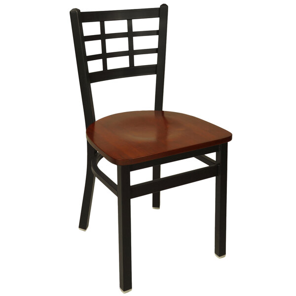 A BFM Seating black metal side chair with a mahogany wood seat.