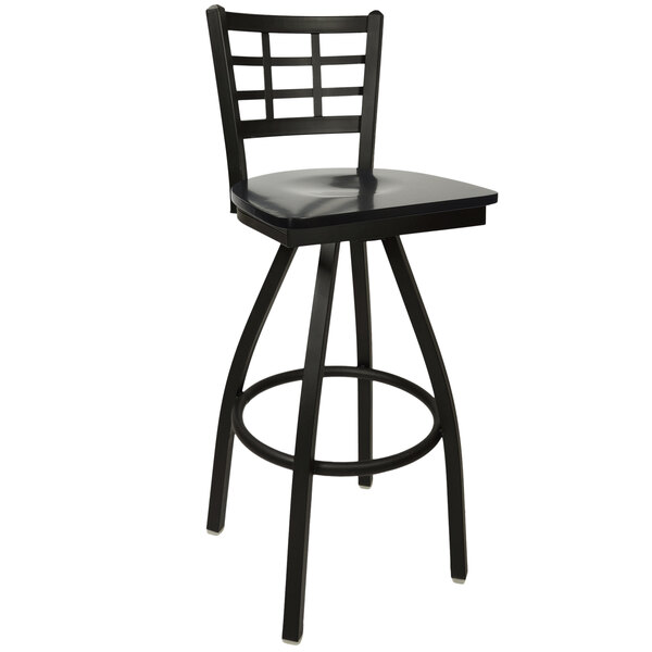 A BFM Seating black metal bar stool with a black wood seat.