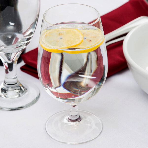 A Spiegelau Soiree water goblet with a lemon slice in it.
