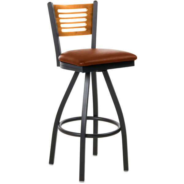 A BFM Seating metal bar stool with a light brown vinyl cushion and wooden back.