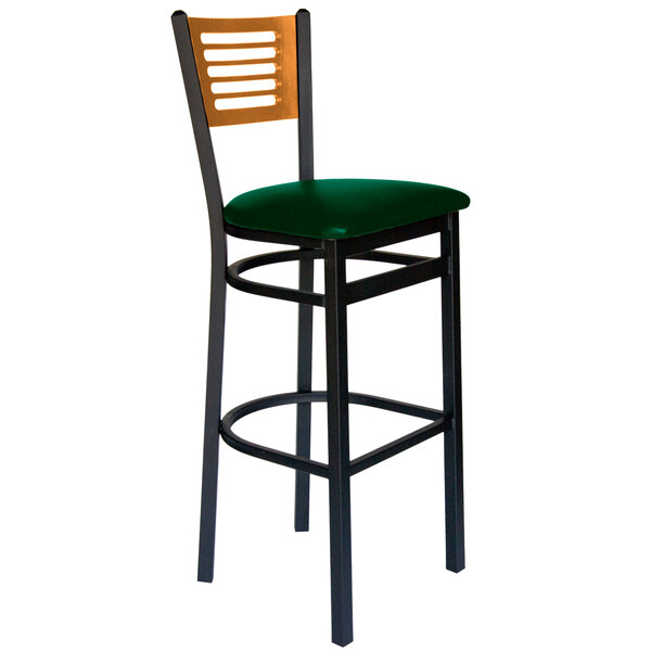 A BFM Seating black metal bar chair with a green vinyl seat.