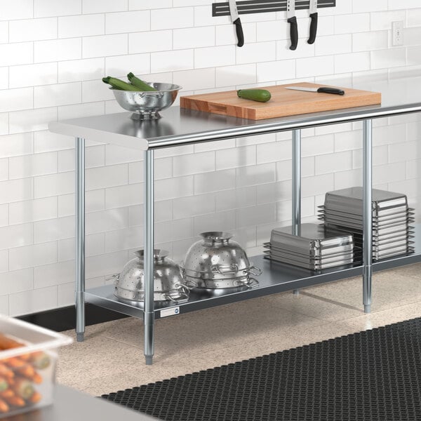 A Steelton stainless steel work table with undershelf in a professional kitchen.