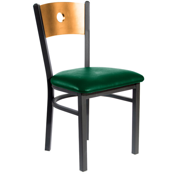 A black metal BFM Seating restaurant chair with a natural wooden back and green vinyl seat.