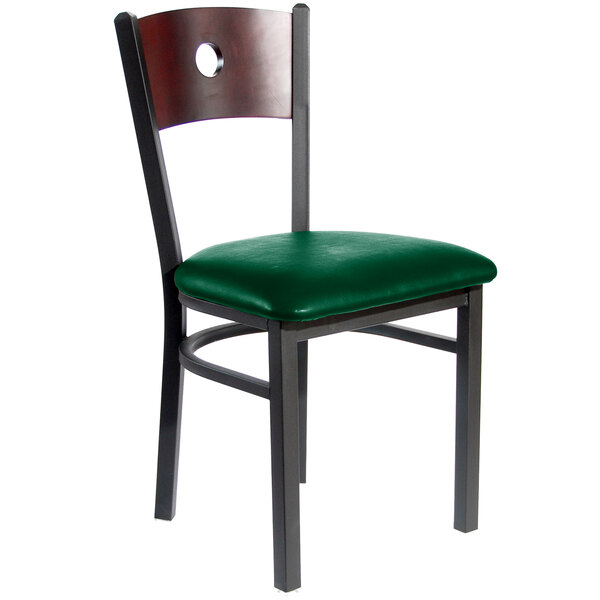 A BFM Seating black metal side chair with mahogany back and green vinyl seat.