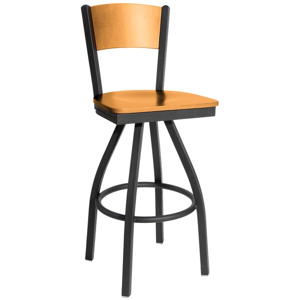 A black metal bar stool with a wooden seat and back.