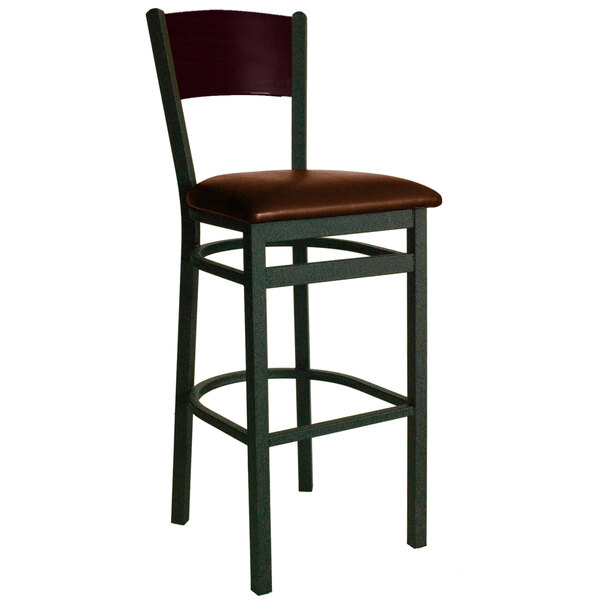 A BFM Seating bar stool with a light brown vinyl seat and black metal frame with a mahogany finish wooden back.
