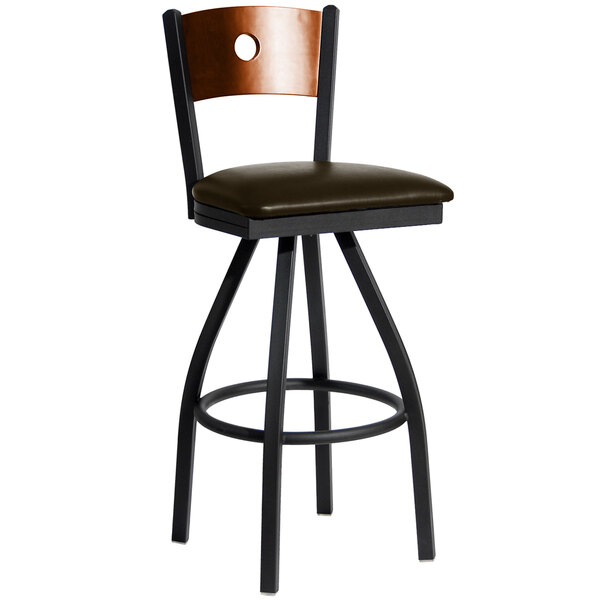 A black metal BFM Seating bar stool with a cherry wooden back and dark brown vinyl swivel seat.