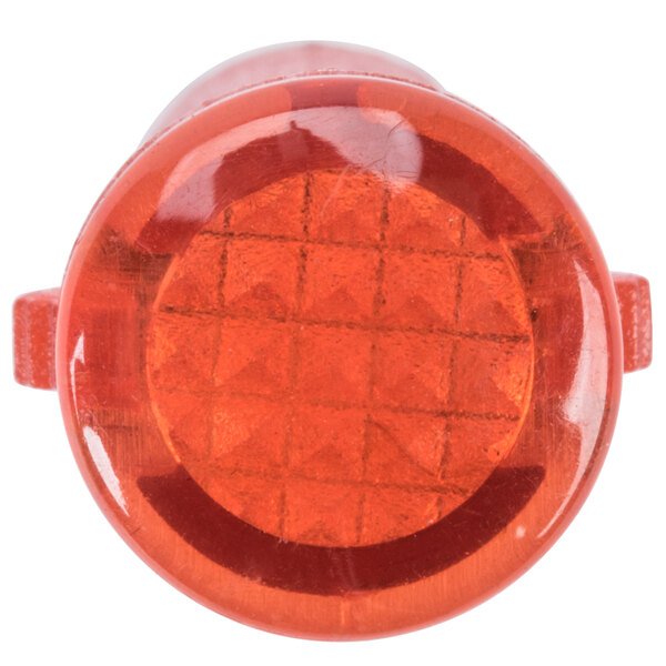 A red plastic round light with a white background.