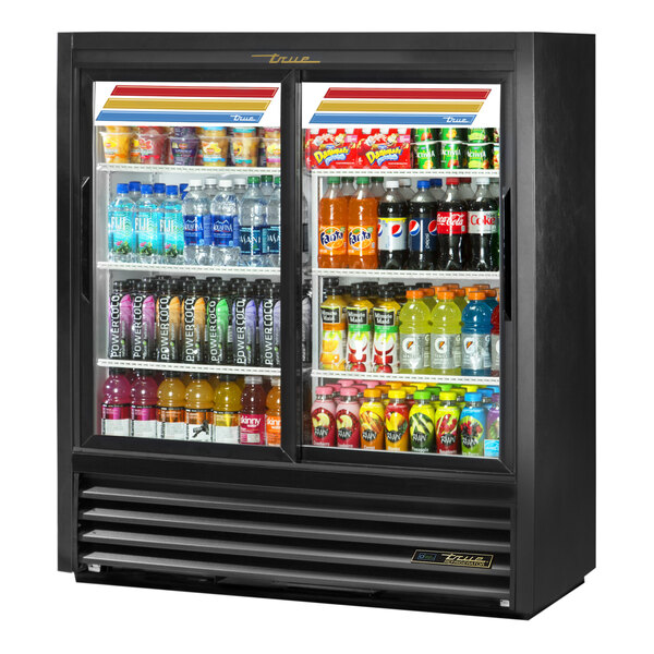 A True black convenience store merchandiser refrigerator with sliding glass doors filled with beverages.
