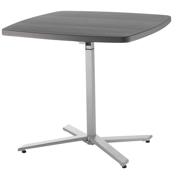 A NPS Cafe Time adjustable height table with a black top and metal base.