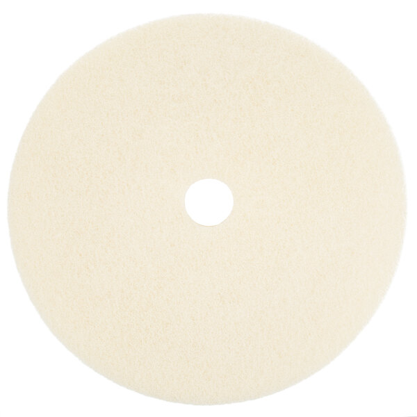 A beige circular floor pad with a hole in the middle.
