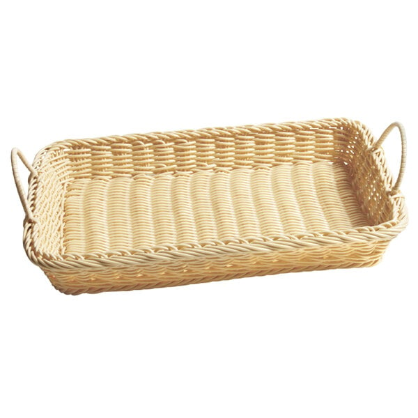 A natural rectangular plastic basket with handles on a counter in a bakery display.