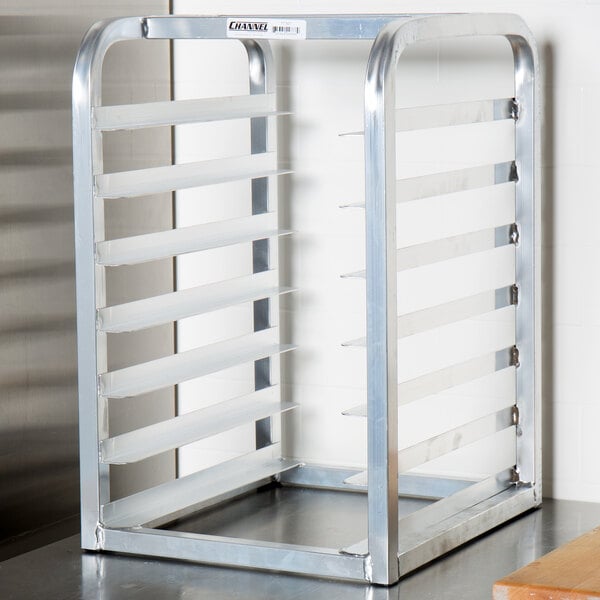 A Channel metal countertop rack with 7 half bun/sheet pans on it.