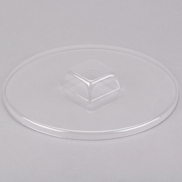A clear plastic lid with a circular base.