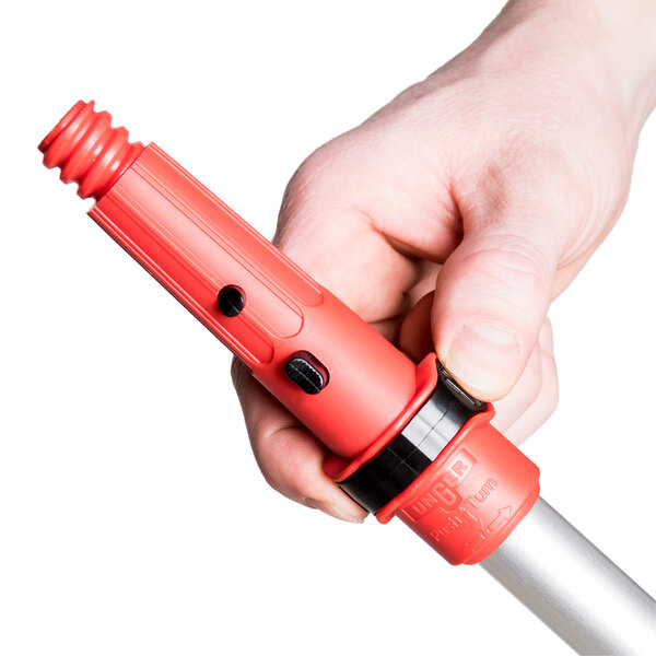 A hand holding a red Unger ErgoTec locking cone.