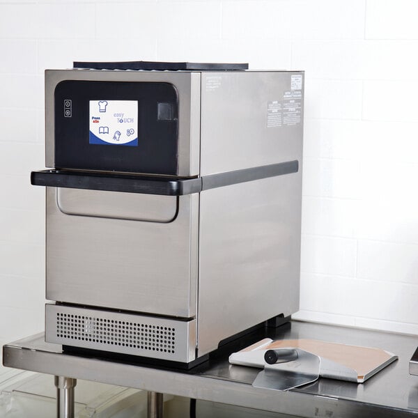 A Merrychef Eikon E2s countertop rapid cook oven on a stainless steel table.