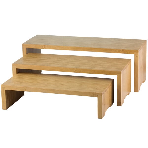 A Tablecraft bamboo 3-piece cascade riser set on a wooden shelf.