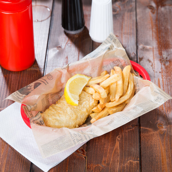 A fish and chips in a basket lined with American Metalcraft newspaper deli wrap.
