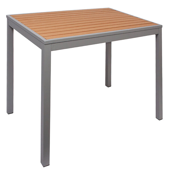 A BFM Seating Longport aluminum table with a synthetic teak top.