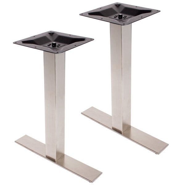 A pair of stainless steel BFM Seating table bases with black knobs.
