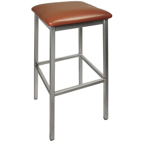 A BFM Seating Trent clear coated steel bar stool with a light brown vinyl cushion on a black surface.