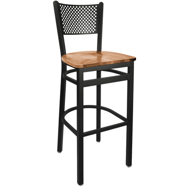 A BFM Seating black steel restaurant bar stool with a wooden seat.