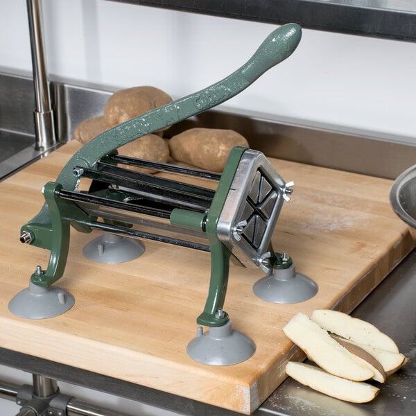 A Choice Prep French Fry Cutter on a cutting board slicing a potato.