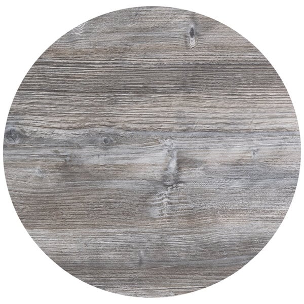A BFM Seating Midtown circular wood tabletop in driftwood finish.