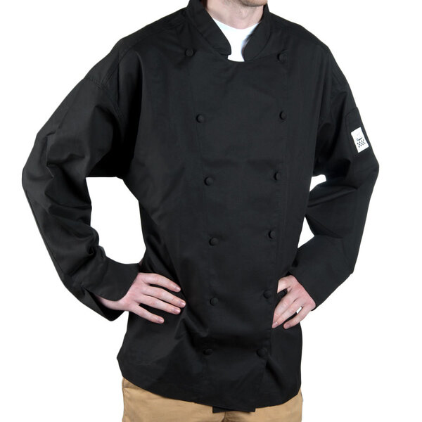 A man wearing a black Chef Revival long sleeve chef coat with a Cuisinier logo.