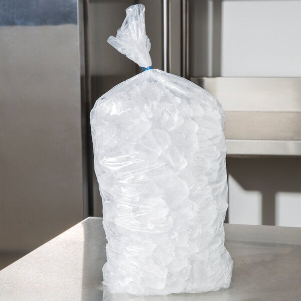 A clear plastic bag of ice on a table.